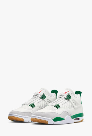 A pair of white Jordan 4's NIKE SB, with green accents and a gum sole